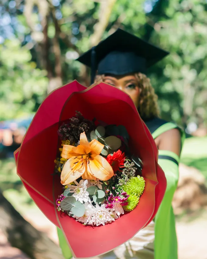 uSmokolo Shots graduation portrait with a bouquet